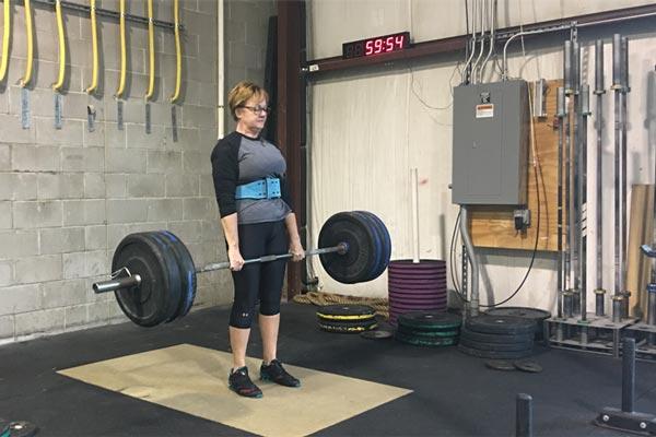 Barb Mueller deadlifts 225 lbs for a triple