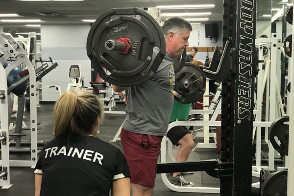 coaching the squat in a commercial gym