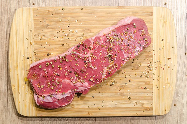 small steak resting on a cutting board