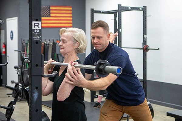 coaching the press start position for a senior lifter