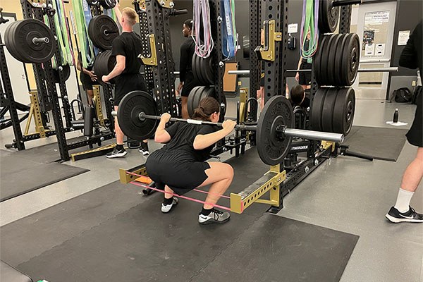cadet working to increase rom after acl surgery by using the squat