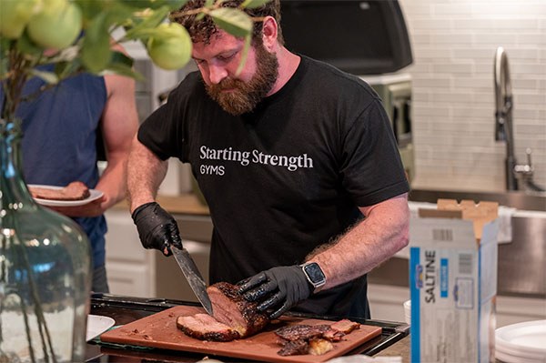 brent carter serves brisket to gym owners and franchise team members at the annual retreat