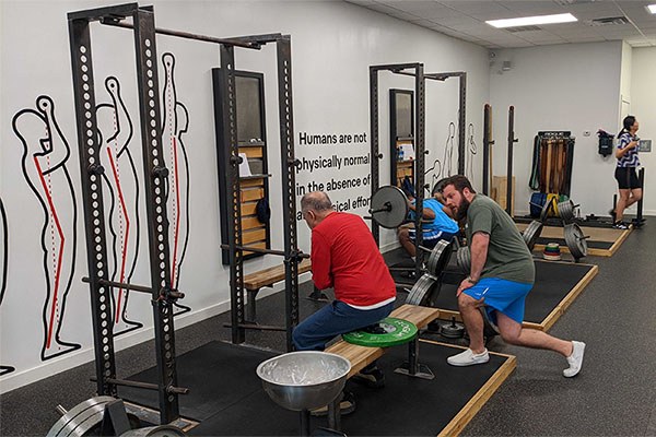 tony stein coaches a modified squat for a lifter recovering from a stroke