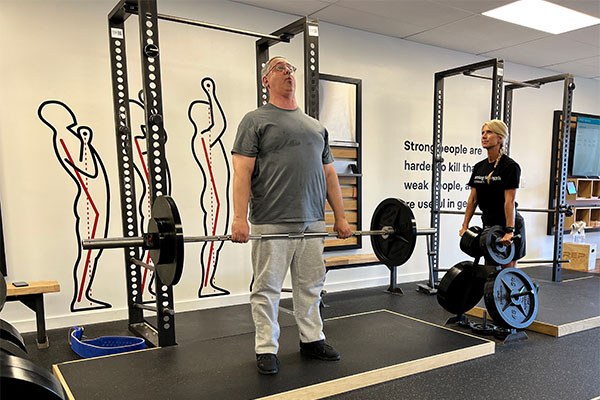 camisha coaches hirsh through deadlifts to rehab his back injury