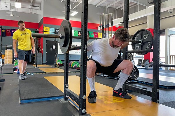 brad squatting at the starting strength training camp in omaha