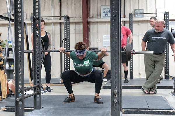 gretchen at the bottom of a squat at the june starting strength seminar