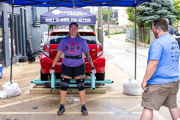 anna finishes a rep in the car deadlift event at the charm city strongwoman contest