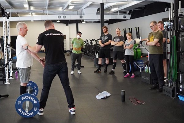 coaching the internal rotation of the arms in a proper deadlift
