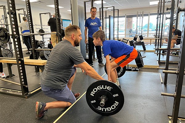 chris teaches the deadlift to 13-year-old samuel