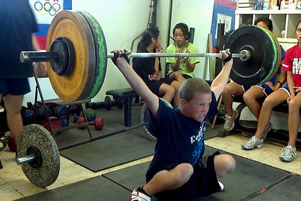 young weightlifter racks a snatch