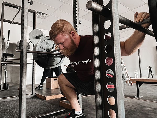 andrew lewis performs the first squats at starting strength tulsa