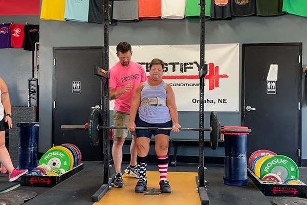 judy locks out a 125 pound deadlift in her first competition