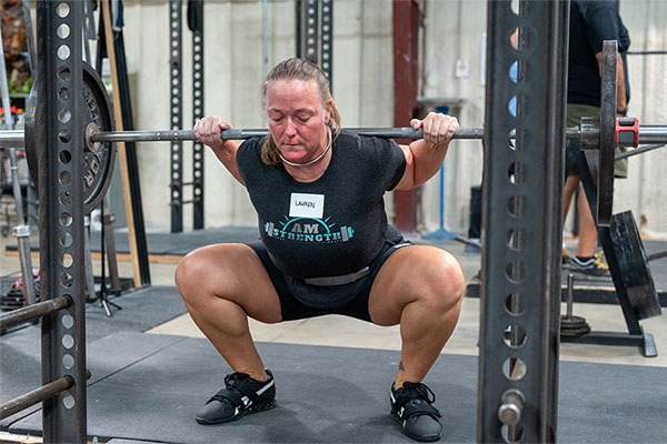 lauren at the bottom of a squat at a self-sufficient lifter camp