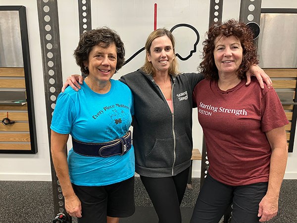 group photo of three members of a 9am class at starting strength boston