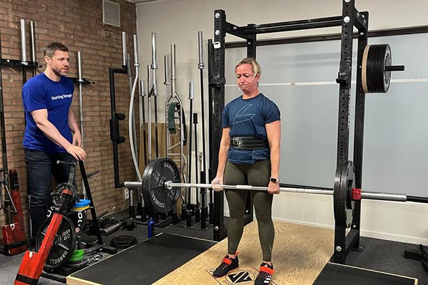 line locks out a deadlift at the starting strength training camp in brussels