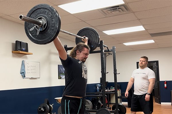 andrew lewis coaching a lifter