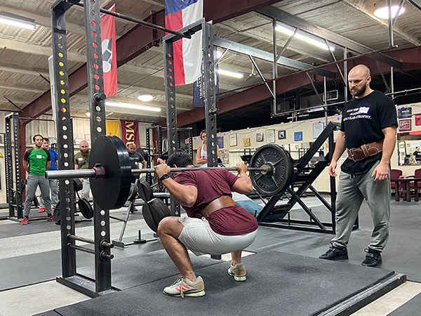 xavier squatting at the starting strength seminar in december 2022