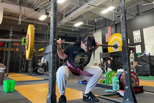 maddie squats sets of 5 at 55 kg at testify strength and conditioning in omaha