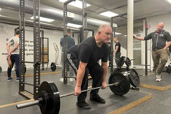 rich sets up to deadlift at the starting strength training camp in boston