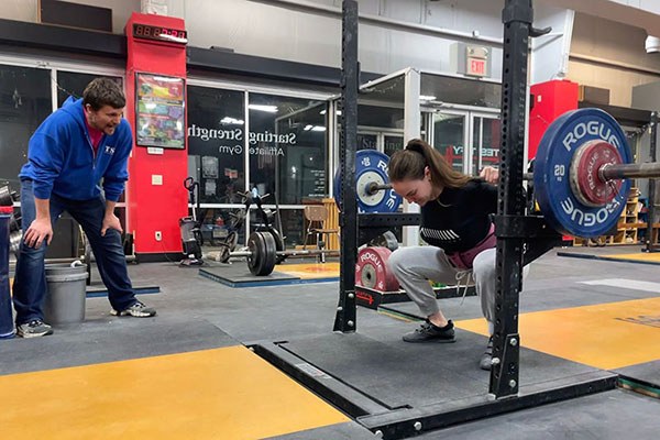 maddie works on leaning over as she squats 75 kg for a triple in omaha