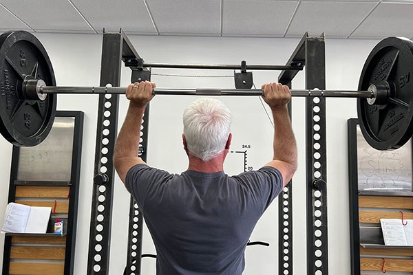 close up of a lifter in the middle of a press