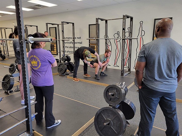 alex ptacek teaches the squat at a starting strength training camp in chicago