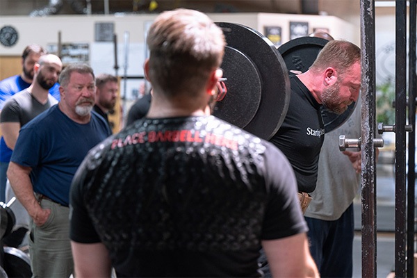 brandon martin squats at a starting strength seminar in texas