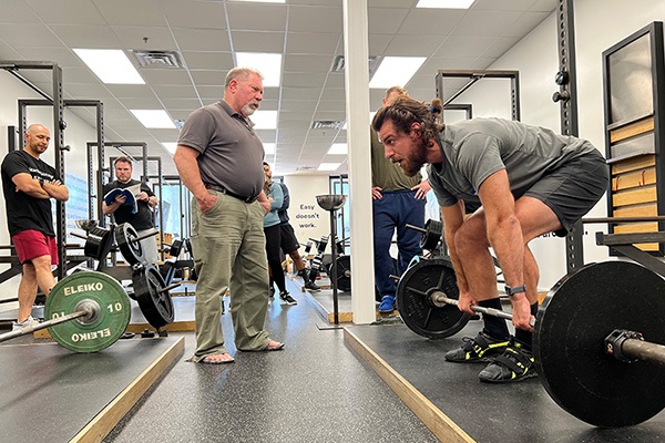 johnny vitatoe takes the slack out of the bar in preparation for a deadlift