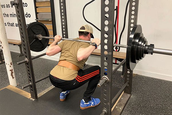 jeremy squats at starting strength boston while in town at a medical conference