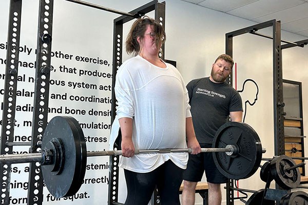 lexi locks out a 245 deadlift pr at a starting strength training camp