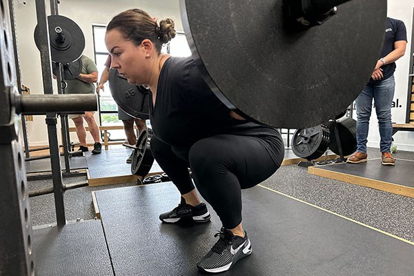 poli squatting at the starting strength training camp