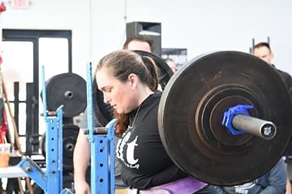 lifter prepares to squat at the stronger together competition