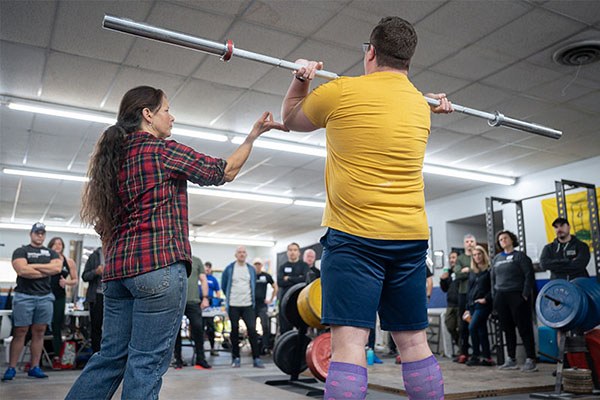 stef bradford teaching the power clean at a starting strength seminar