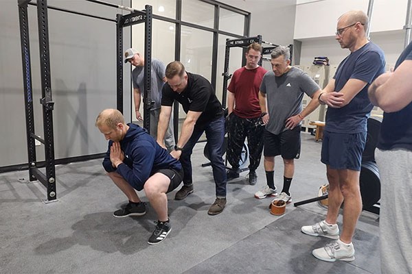grant broggi teaches the bottom position of the squat