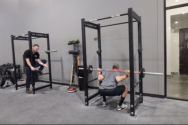 grant coaches a lifter in the squat
