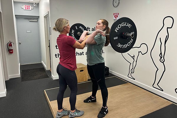 camisha coaches olivia on the power clean at starting strength cincinnati