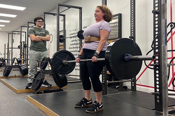 lisa locks out a 225 lb deadlift at starting strength columbus