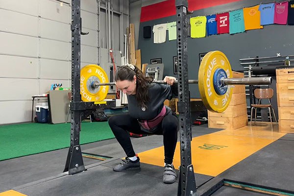 maddie squatting her fives at testify strength and conditioning