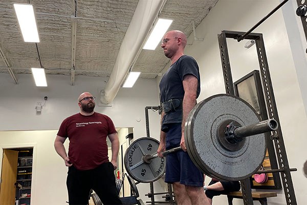 ethan coaches leon's deadlift at starting strength austin