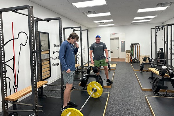 matt lovette coaches a lifter on the deadlift during his visit to starting strength atlanta