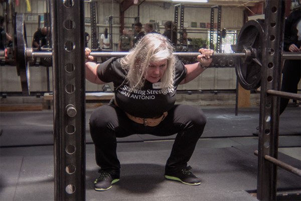 karin at the bottom of a squat at the starting strength seminar