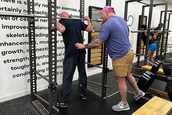 adam martin cues a lifter's low back position