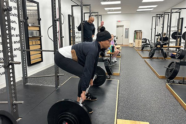 tarya squeezes slack out as she prepares to deadlift