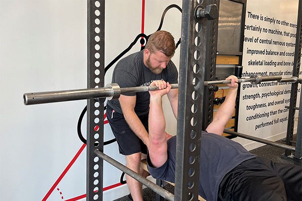 andrew teaches leg drive by blocking the shoulders in the bench press