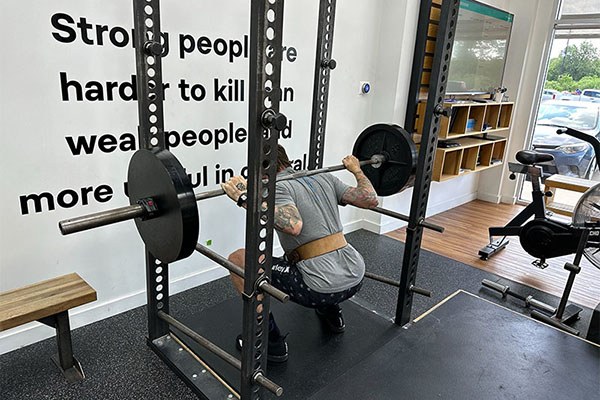 sean at the bottom of a squat at starting strength katy
