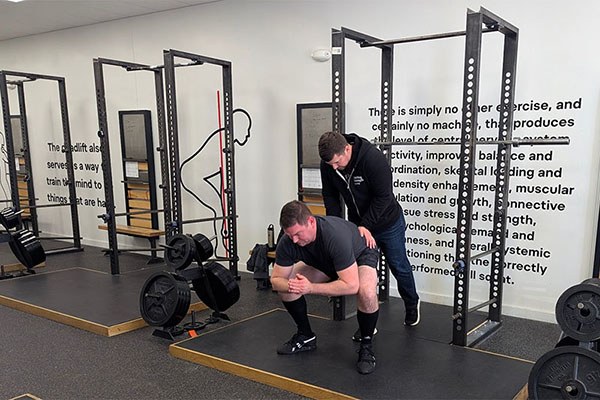 jarret beck teaches hip drive in the squat