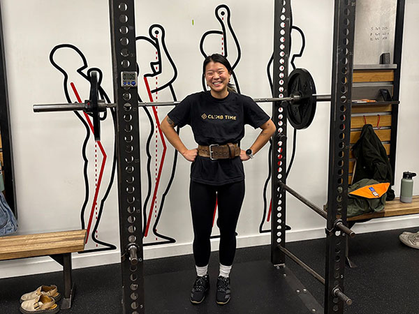 mia smiles after a 135 lb squat