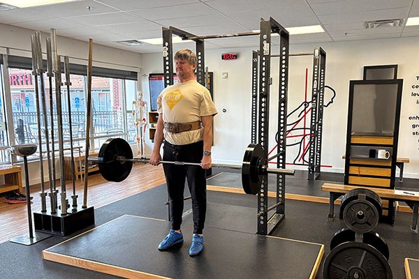 evgeny locks out a deadlift at a starting strength training camp
