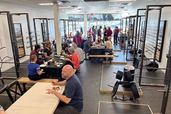 members eat at a potluck event in indianapolis