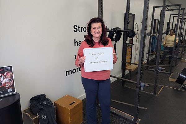 lea roberts smiles while celebrating her three year anniversary at the gym